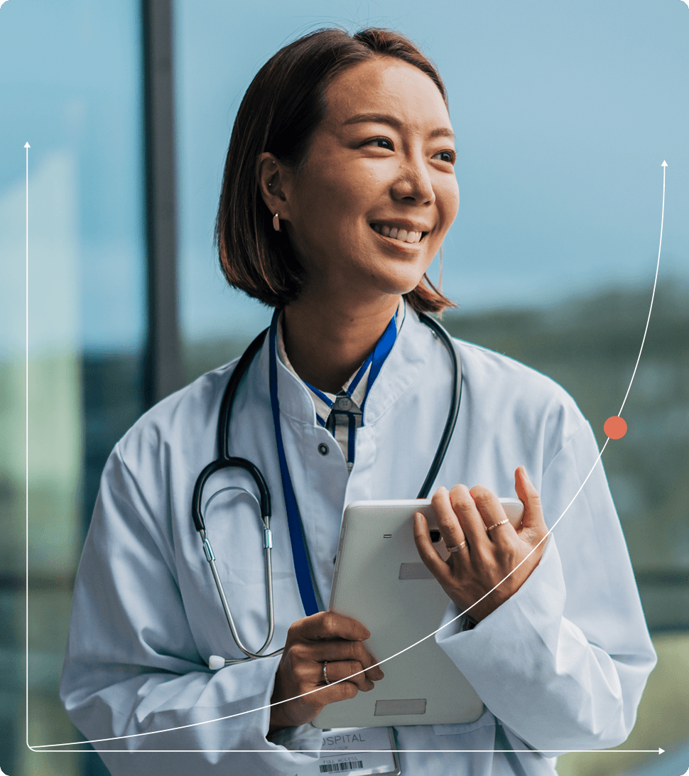 Smiling doctor holding tablet computer
