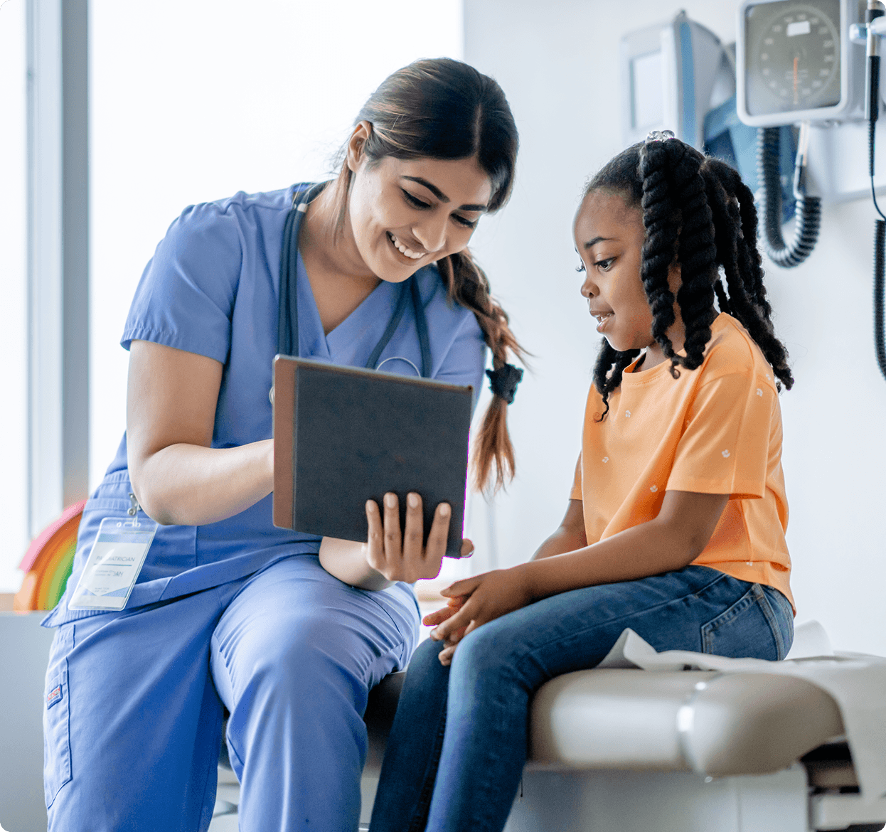 Pediatric doctor showing female child patient tablet computer