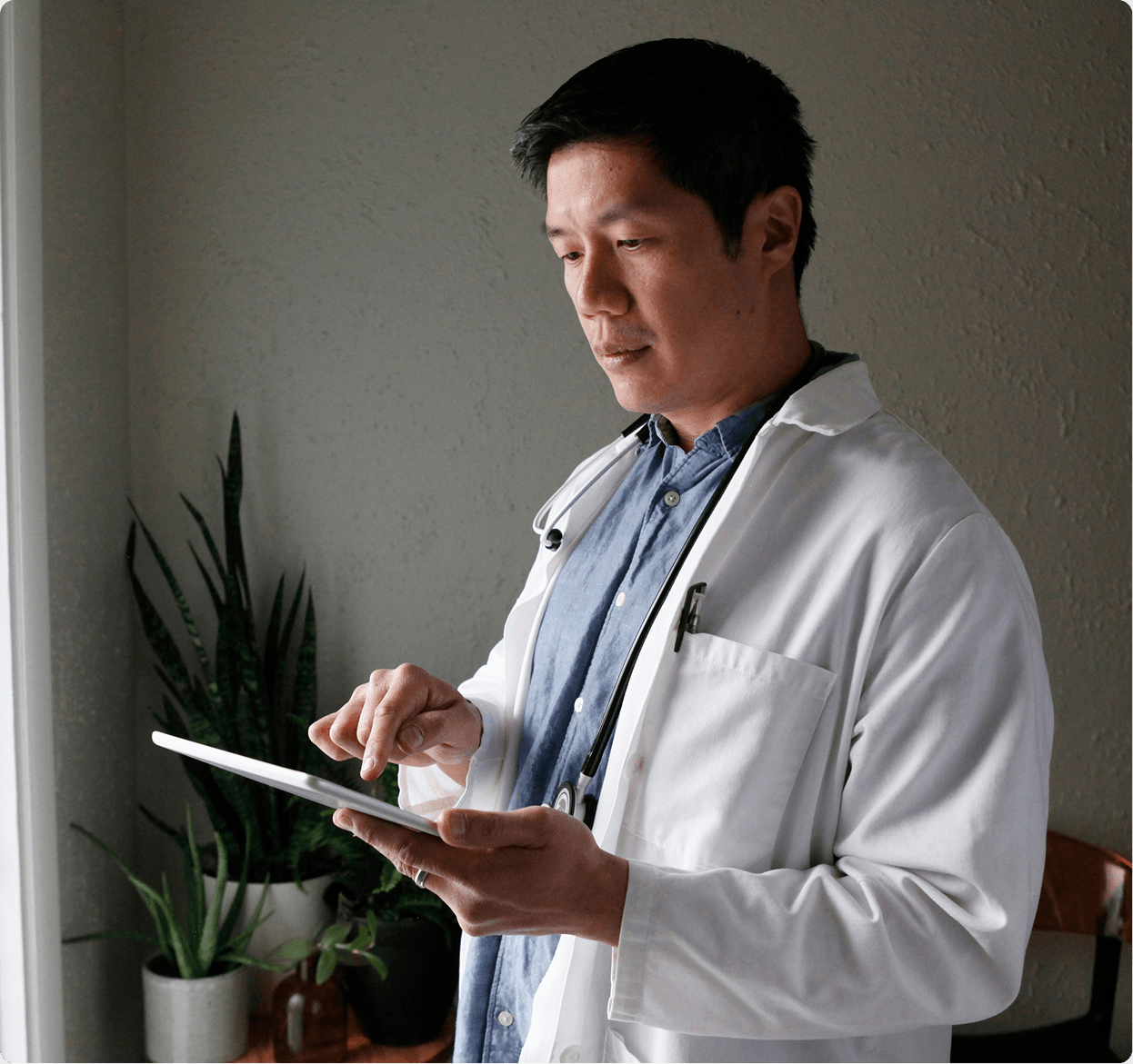 Male doctor looking at laptop computer