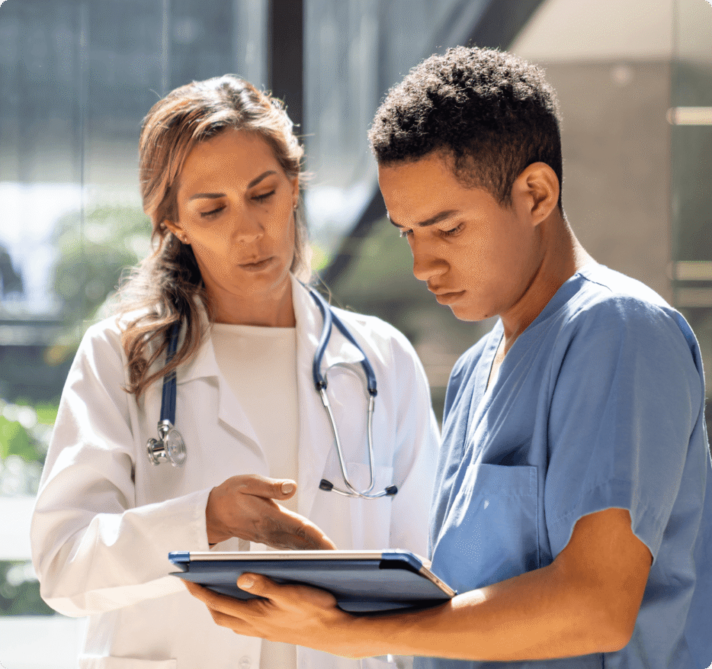Female and male doctor looking at laptop computer