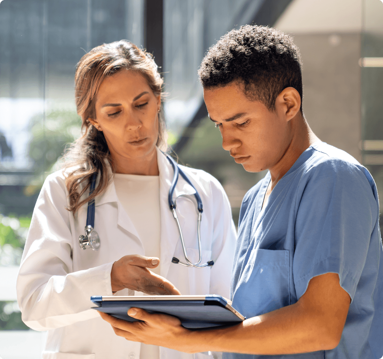 Female and male doctor looking at laptop computer